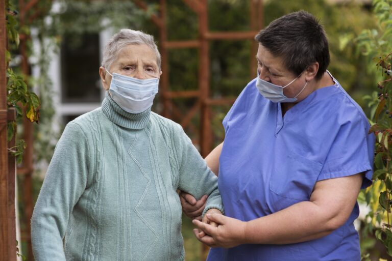 female-nurse-taking-care-older-woman-with-medical-mask-768×513