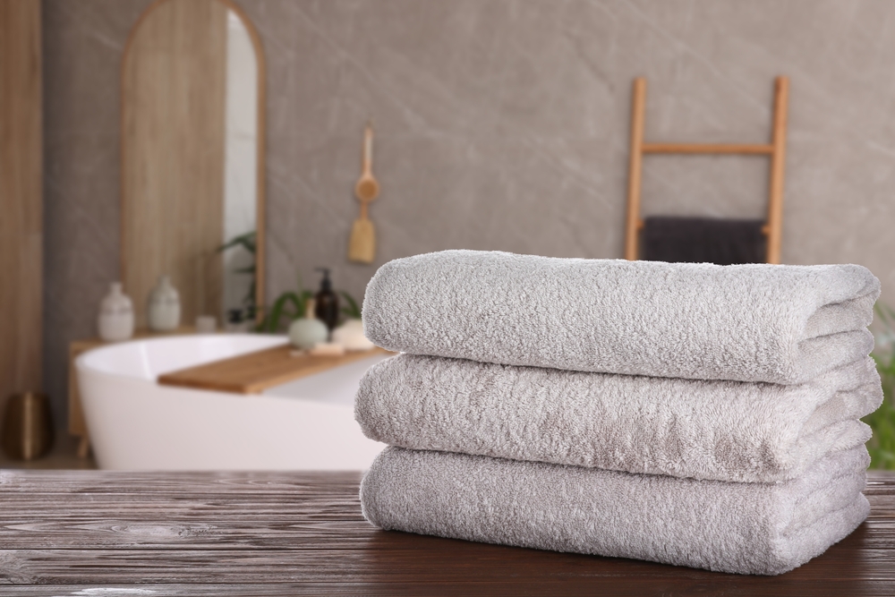 White,Clean,Towels,On,Wooden,Table,In,Bathroom.,Space,For